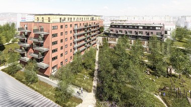 Das Bild zeigt ein rotes Haus mit mehreren Wohnungen und Balkonen mitten in einer grünen Umgebung