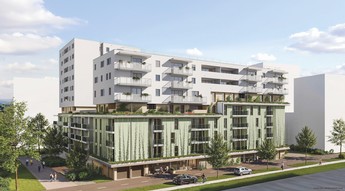 Darstellung des zukünftigen Gemeindebaus in der Ljuba -Welitsch-Promenade 18. Die Fassade ist begrünt und das Gebäude ist umgeben von Bäumen. Im Hintergrund sind auch andere Gebäude zu sehen.