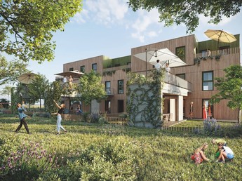 Außenaufnahme der neuen Siedlung Wienerfeld West. Die Fassade ist mit Holz verkleidet und vor dem dreistöckigen Gebäude sind große Wiesenflächen dargestellt.