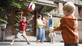 Kinder spielen in einem Gemeindebauhof.